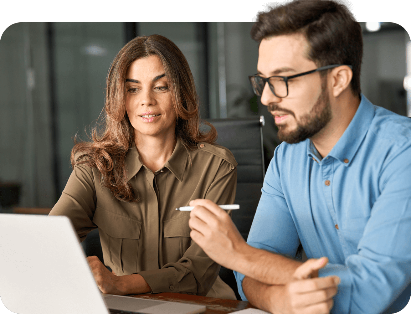 Coworkers looking at laptop screen